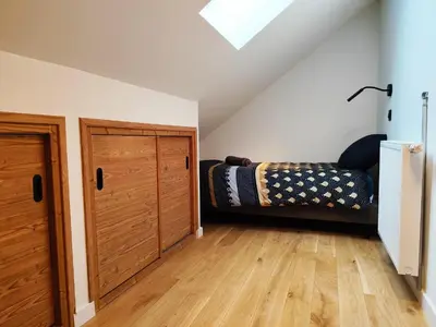 a attic room with a bed and a door at La Source in Saint-Gervais-les-Bains