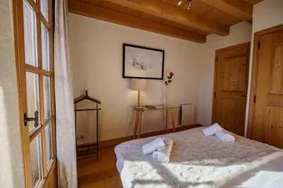 a bedroom with a bed with towels on it at Chalet Panorama in Combloux