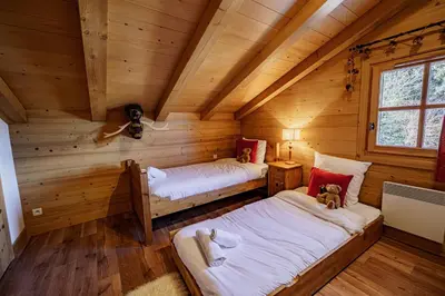 a room with two beds in a log cabin at Chalet Panorama in Combloux