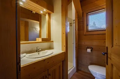 a bathroom with a sink and a mirror at Chalet Panorama in Combloux