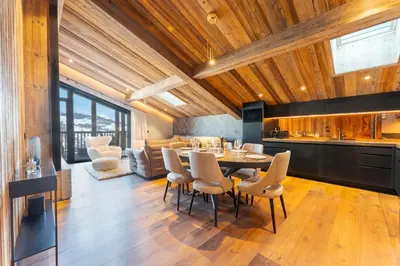a kitchen and dining room with a table and chairs at Observatoire Sompteux Loft 3CHBR Elegant Vues in Megève