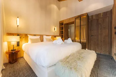 a bedroom with a large white bed with two stuffed animals on it at Observatoire Sompteux Loft 3CHBR Elegant Vues in Megève