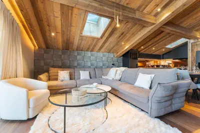 a living room with a couch and a table at Observatoire Sompteux Loft 3CHBR Elegant Vues in Megève