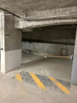 an empty parking garage with a parking sign on the floor at Pied des pistes, piscine, jacuzzi in Flaine