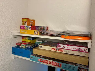 a stack of books sitting on a wall at Pied des pistes, piscine, jacuzzi in Flaine