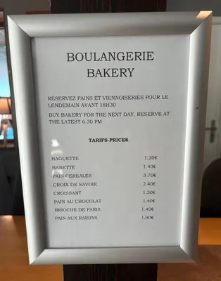a white framed picture of a banquet bakery menu at Pied des pistes, piscine, jacuzzi in Flaine