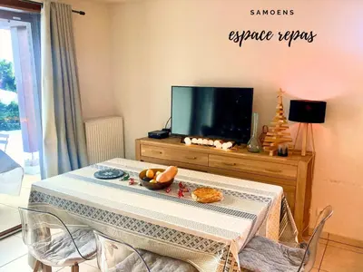a living room with a table and a tv at Rent cozy apartment sleeps 6 in SAMOENS in Samoëns