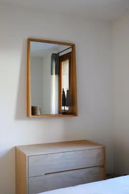 a bedroom with a dresser and a mirror on the wall at Rent cozy apartment sleeps 6 in SAMOENS in Samoëns