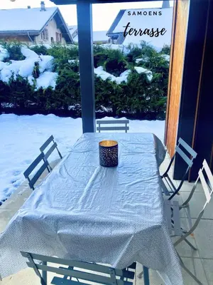 a table with a bowl on top of it in the snow at Rent cozy apartment sleeps 6 in SAMOENS in Samoëns