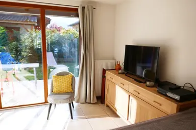 a living room with a television on a wooden dresser at Rent cozy apartment sleeps 6 in SAMOENS in Samoëns