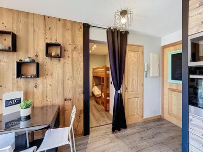 a room with a wooden wall with a table and chairs at Appartement 2 pièces avec coin montagne, parking, vue Mont Blanc - FR-1-560-167 in Combloux