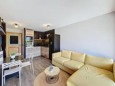 a living room with a couch and a table at Appartement 2 pièces avec coin montagne, parking, vue Mont Blanc - FR-1-560-167 in Combloux