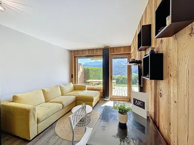 a living room with a couch and a glass table at Appartement 2 pièces avec coin montagne, parking, vue Mont Blanc - FR-1-560-167 in Combloux