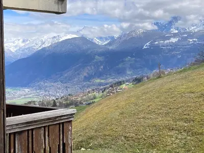 a view of a mountain range with snow capped mountains at Terrasse du MtBlanc in Combloux