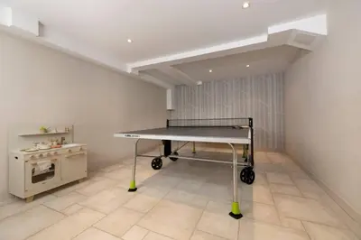 a ping pong table in a room with a stove at Folettes Chalet 4CH Jardin Vue Cheminee Jacuzzi in Chamonix-Mont-Blanc