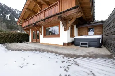 a house with a hot tub on a deck at Folettes Chalet 4CH Jardin Vue Cheminee Jacuzzi in Chamonix-Mont-Blanc