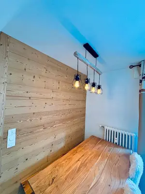 a room with a wooden wall with lights on it at L'écrin des quatre horizons in Saint-Gervais-les-Bains