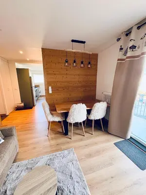 a dining room with a table and two chairs at L'écrin des quatre horizons in Saint-Gervais-les-Bains