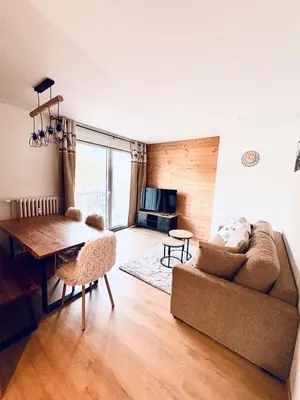 a living room with a couch and a table at L'écrin des quatre horizons in Saint-Gervais-les-Bains