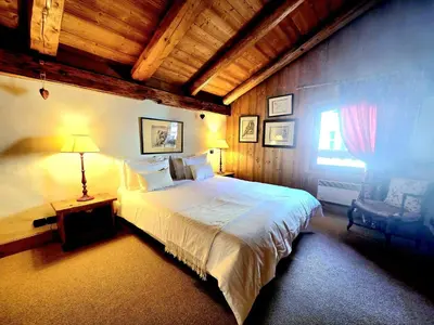 a bedroom with a large bed and a window at A Soulful Alpine Retreat in Megève in Megève