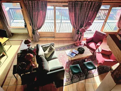 a living room with a couch and chairs and a table at A Soulful Alpine Retreat in Megève in Megève