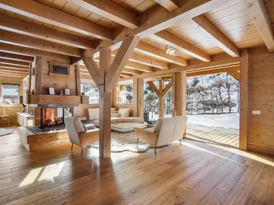 a living room with a fireplace and wooden ceilings at Chalet de Luxe: 13 pers, Jacuzzi, Animaux Admis - FR-1-663-60 in Saint-Gervais-les-Bains