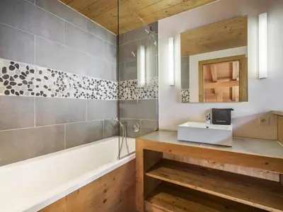 a view from the balcony of a cabin with snow covered mountains at Chalet de Luxe: 13 pers, Jacuzzi, Animaux Admis - FR-1-663-60 in Saint-Gervais-les-Bains