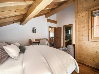 a kitchen with wooden cabinets and a large stove at Chalet de Luxe: 13 pers, Jacuzzi, Animaux Admis - FR-1-663-60 in Saint-Gervais-les-Bains