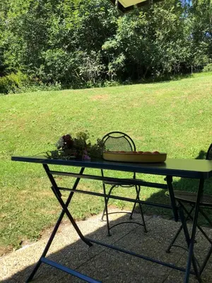 a green picnic table with a basket of flowers on it at Full nature, 4 people, Saint-Gervais, Chamonix in Saint-Gervais-les-Bains