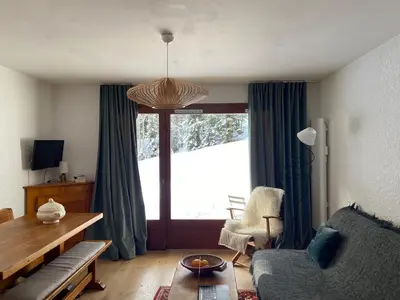 a living room with a couch and a large window at Full nature, 4 people, Saint-Gervais, Chamonix in Saint-Gervais-les-Bains