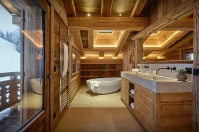 a large bathroom with a tub and a sink at Chalet Lauda - OVO Network in Saint-Nicolas-de-Véroce