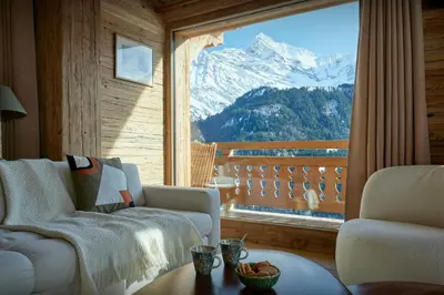 a living room with a view of a snow covered mountain at Chalet Lauda - OVO Network in Saint-Nicolas-de-Véroce