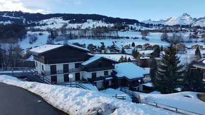 a building covered in snow on a mountain at Studio à 2 mn à pied des pistes de Mégève in Demi-Quartier