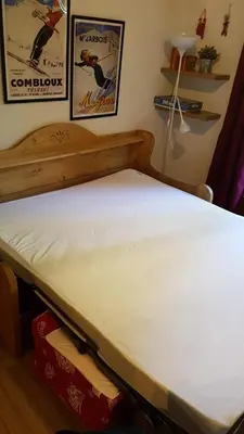 a bed with a white mattress in a room at Studio à 2 mn à pied des pistes de Mégève in Demi-Quartier
