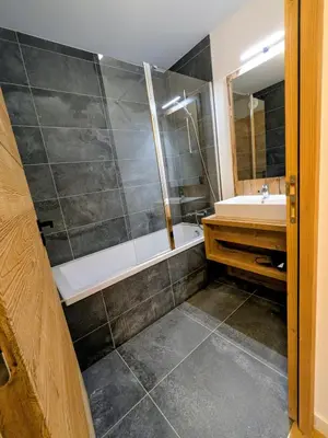 a bathroom with a shower and a tub and a sink at Les Sources de Canopée A0105 By Avecoeur in Saint-Gervais-les-Bains