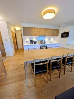 a kitchen with a large wooden table and chairs at Les Sources de Canopée A0105 By Avecoeur in Saint-Gervais-les-Bains