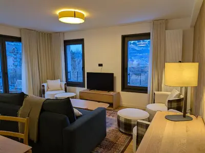 a living room with a couch and a tv at Les Sources de Canopée A0105 By Avecoeur in Saint-Gervais-les-Bains