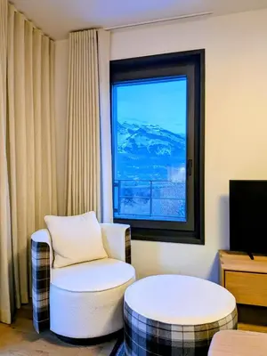 a living room with a chair and a window at Les Sources de Canopée A0105 By Avecoeur in Saint-Gervais-les-Bains