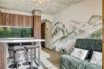 a kitchen with a mountain mural on the wall at Appartement F&F in Cordon