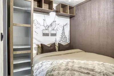 a bedroom with a bed and two hanging shelves at Appartement F&F in Cordon