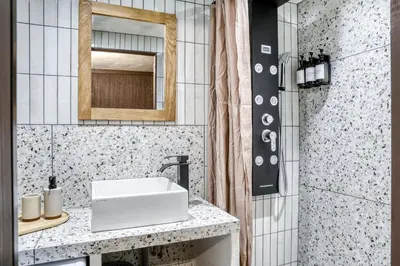 a bathroom with a white sink and a mirror at Appartement F&F in Cordon