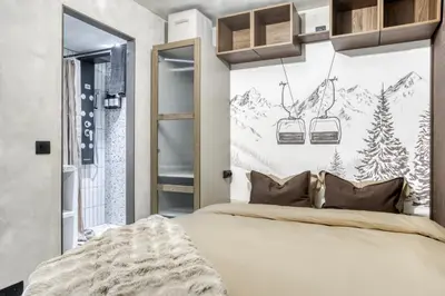 a bedroom with a bed and a mountain mural at Appartement F&F in Cordon