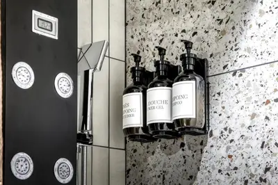 three bottles of wine on a wall next to a refrigerator at Appartement F&F in Cordon