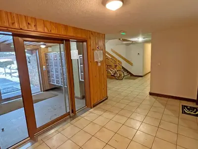 a hallway with sliding glass doors in a house at Appartement T2 central avec balcon et casier à skis - FR-1-629-154 in Samoëns