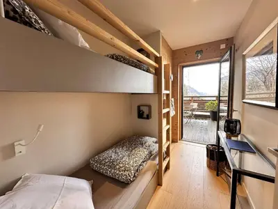a small bedroom with bunk beds in a tiny house at Appartement Familial 3 Pièces Pied de Piste avec Parking - FR-1-572-350 in Arâches-la-Frasse