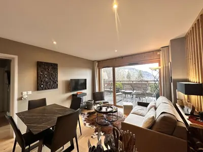 a living room with a couch and a table at Appartement Familial 3 Pièces Pied de Piste avec Parking - FR-1-572-350 in Arâches-la-Frasse