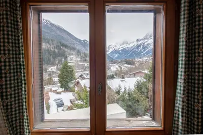 a window with a view of a snow covered mountain at 2 bedroom, balcony and parking near Bellevue lift in Les Houches