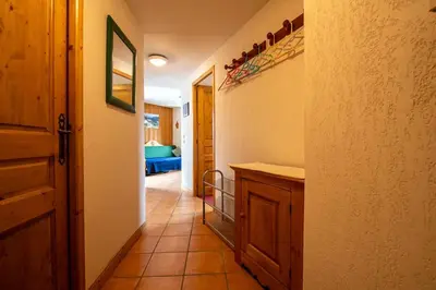 a hallway of a house with a kitchen and a room at 2 bedroom, balcony and parking near Bellevue lift in Les Houches