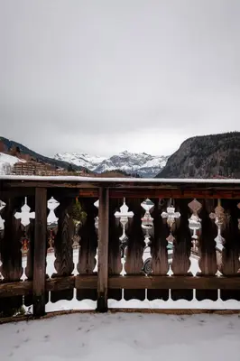 a wooden fence with snow on the mountains at 2 bedroom, balcony and parking near Bellevue lift in Les Houches