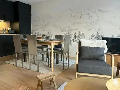 a dining room with a table and chairs at Renovated Flat At The Ski Bus Stop In Les Carroz in Arâches-la-Frasse